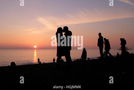 Brighton, Sussex, UK. 22 janvier, 2017. Un couple profitez d'un moment romantique sur la plage de Brighton à mesure que le soleil se couche derrière eux au crépuscule, après une froide mais belle journée sur la côte sud Crédit : Simon Dack/Alamy Live News Banque D'Images