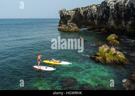 Les femmes bénéficiant du Stand Up Paddle Surf. Tarifa, Costa de la Luz, Cadix, Andalousie, espagne. Banque D'Images