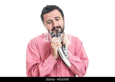 Businessman holding sneakers Banque D'Images