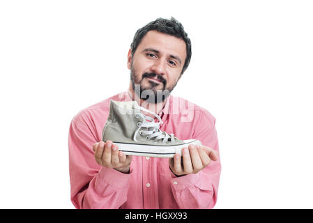 Businessman holding sneakers Banque D'Images