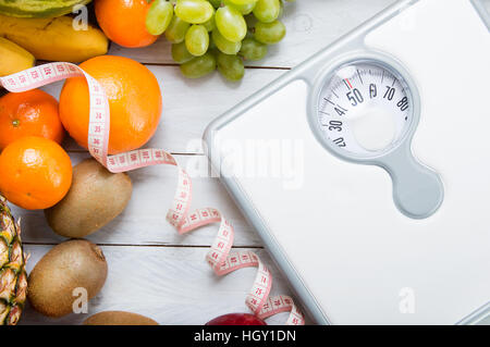 Pile de fruits, balance des blancs et sur mesure mètre sur planche de bois. Concept de l'alimentation et mode de vie sain Banque D'Images