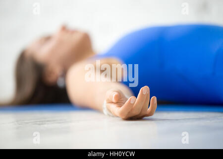 Jeune femme séduisante dans Corpse pose, fond studio blanc Banque D'Images