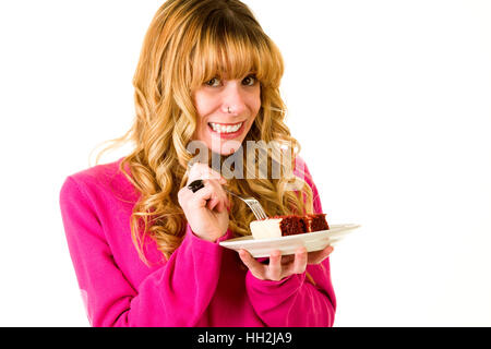 Une jolie blonde woman enjoying un morceau de gâteau Banque D'Images