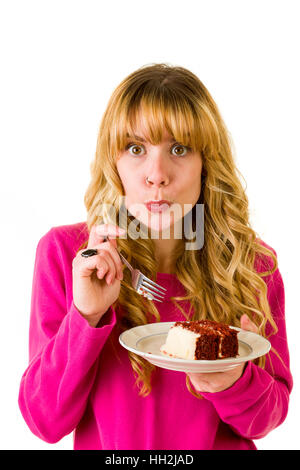 Une jolie blonde woman enjoying un morceau de gâteau Banque D'Images