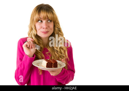 Une jolie blonde woman enjoying un morceau de gâteau Banque D'Images