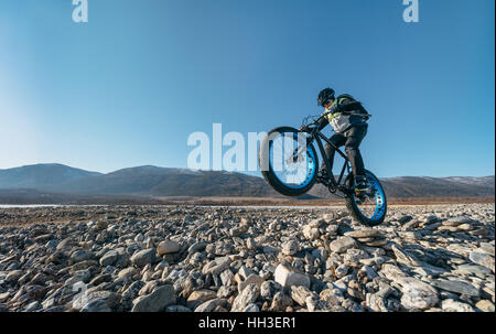 Fatbike aussi appelé vélo fat ou fat-vélo pneus vélo - sur roues pneu large. Cycliste va à son vélo sur le lac gelé. Banque D'Images