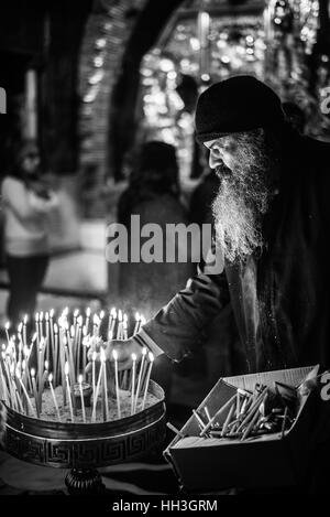 Un dignitaire religieux orthodoxe grec dans la Crucifixion autel dans l'église de Saint Sépulcre sur le Golgotha, Jérusalem, Israël Banque D'Images