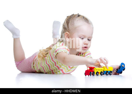 Kid cute little girl playing trains isolated over white Banque D'Images