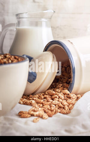 Céréales orge soufflé de répandre de pot de cruche de lait en arrière-plan Banque D'Images