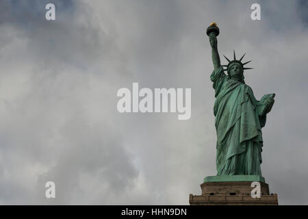 La Statue de la liberté en face de ciel couvert. Liberty Island, New York Harbor, New York, États-Unis d'Amérique. Banque D'Images