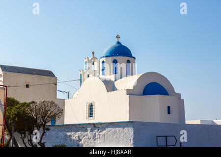 À dôme bleu typique village blanc près de l'église orthodoxe Venetsanos Winery, Santorini sur une journée ensoleillée avec ciel bleu Banque D'Images