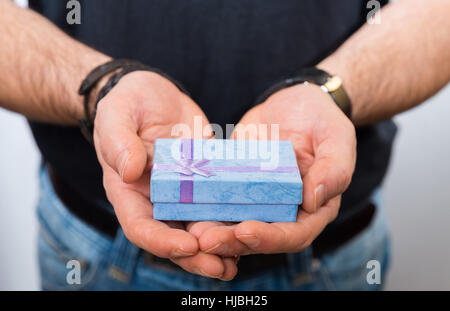 Men's hand holding gift box Banque D'Images