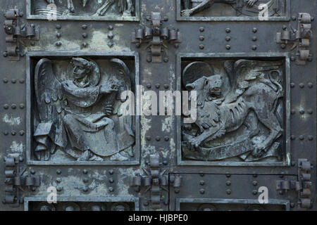 L'homme ailé de Saint Matthieu et le lion ailé de Saint Marc. Détail de la porte de bronze de la Basilique de la Santa Cruz (Basilique de la Sainte Croix) dans le Valle de los Caidos (vallée de l'armée déchue) près de Madrid, Espagne. Banque D'Images