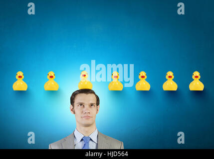 Funny businessman with yellow rubber duck toy Banque D'Images