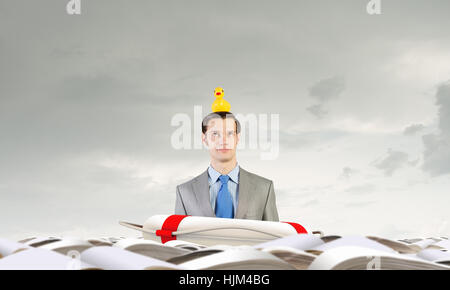 Funny businessman with yellow rubber duck toy Banque D'Images
