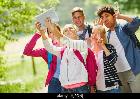 Groupe de jeunes s'amusant et en prenant un ridicule étant selfies Banque D'Images
