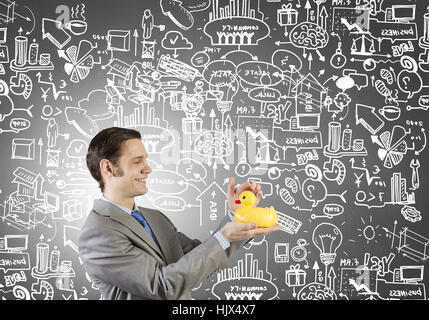Funny businessman with yellow rubber duck toy Banque D'Images