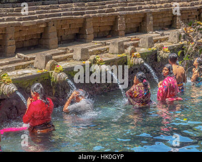 Baignade dans les eaux saintes du Pura Tirta Empul, Bali, Indonésie, Asie du sud-est Banque D'Images