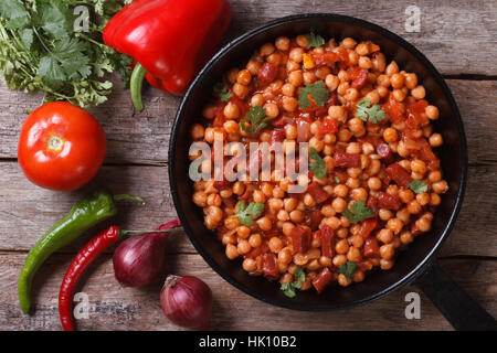 Pois chiches au chorizo dans une casserole close-up et avec les ingrédients sur la table horizontale vue supérieure Banque D'Images