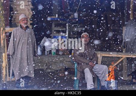 Srinagar, Inde. 25 Jan, 2017. Le Cachemire sous contrôle indien a été témoin d'un des plus lourds de neige au cours des dernières années. Dans la partie nord de Sopore, un vieil homme se réchauffe lui-même avec le feu. Les températures voir aussi basses que moins 15 au Cachemire pendant les hivers Crédit : Eeshan/pairs Pacific Press/Alamy Live News Banque D'Images