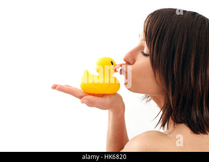 Young woman kissing rubber duck Banque D'Images