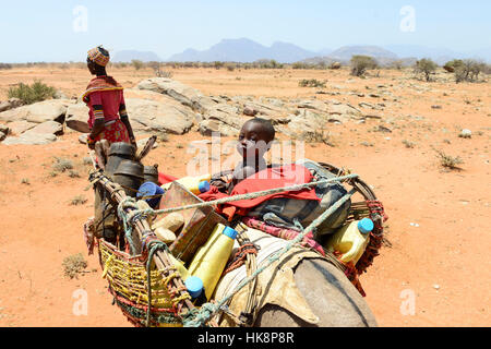 KENYA Samburu, Marsabit, tribu pastorale femme avec enfants sur donkey errer avec leurs troupeaux à la recherche d'eau et de pâturages / KENYA, Samburu, Marsabit Familie mit auf Wanderschaft Eseln und Ziegenherde Banque D'Images