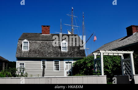 Mystic, Connecticut - 11 juillet 2015 : 18e siècle maison terriers avec toit en mansarde et mâts de 1841 Charles W. Morgan baleinier à Mystic Seaport Banque D'Images