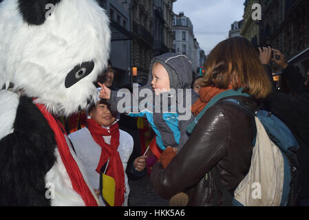 Bruxelles, Belgique. 28 janvier, 2017. Un bébé veut tot touch un homme dans un costume de panda au défilé du Nouvel An chinois à Bruxelles. Credit : Frederik Sadones/Pacific Press/Alamy Live News Banque D'Images