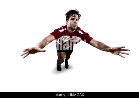 Joueur de Rugby dans un uniforme rouge donnant un s'attaquer. Fond blanc Banque D'Images