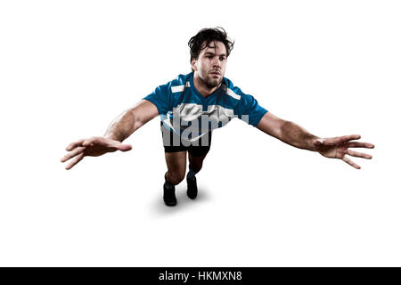 Joueur de Rugby dans un uniforme bleu donnant un s'attaquer. Fond blanc Banque D'Images