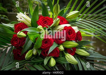 Roses rouges, des lys et des fleurs de palmier Banque D'Images