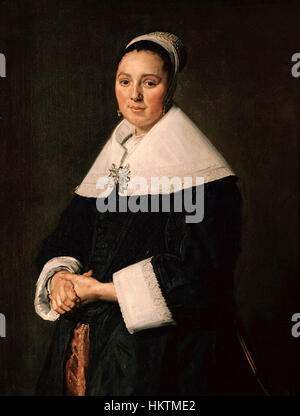 Ce portrait de Frans Hals capture le caractère et la grâce d'une femme de l'âge d'or néerlandais. Connu pour son pinceau animé et sa représentation détaillée, le travail de Hals reflète à la fois le statut social et la personnalité du sujet. La peinture illustre sa capacité à transmettre l’émotion à travers une expression faciale dynamique et des techniques de portrait innovantes. Banque D'Images
