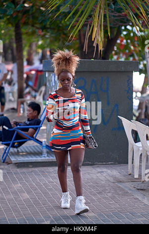Vêtements colorés. Belle jeune femme africaine portant une sublime robe multicolore et sport une coupe fry afro Caribbean liée. Banque D'Images