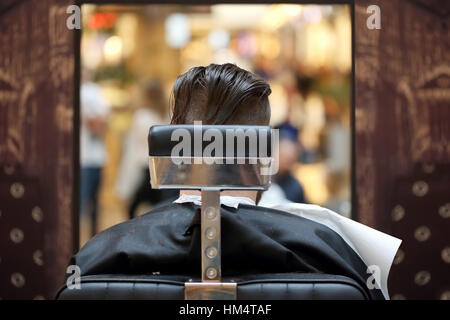 Le client dans le salon de coiffure assis sur une chaise Banque D'Images