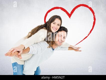 Man giving piggyback ride to woman Banque D'Images