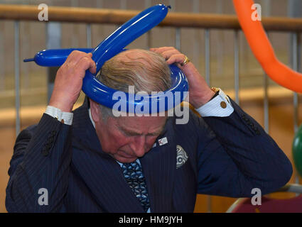 Le Prince de Galles est montré comment faire des chapeaux à partir de ballons au cours d'une visite au Collège de Yavneh, une école juive orthodoxe à Borehamwood, Hertfordshire. Banque D'Images