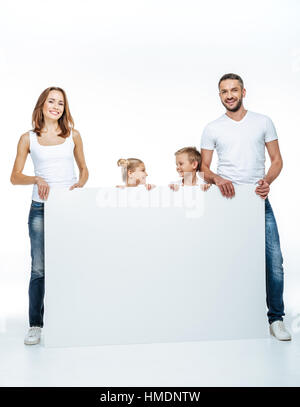 Happy Family holding blank card Banque D'Images