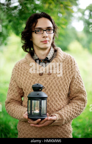 Jeune homme multiraciale romantique close-up portrait, man holding lantern Banque D'Images
