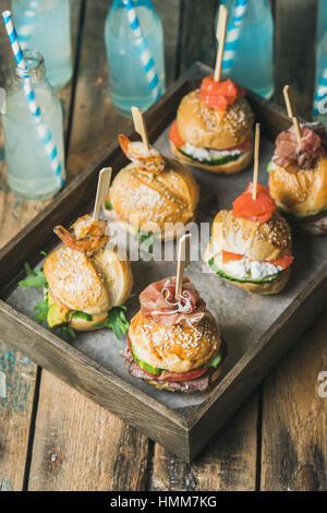 Hamburgers maison en plateau en bois sur fond de table rustique Banque D'Images