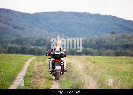 Couple in love bénéficiant d'une campagne randonnée à moto. Banque D'Images