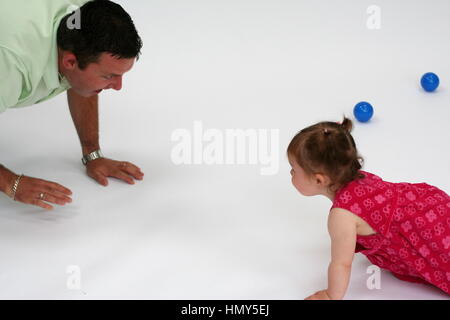 Papa et sa petite fille à jouer ensemble, en rampant père fille concept père et fille Banque D'Images