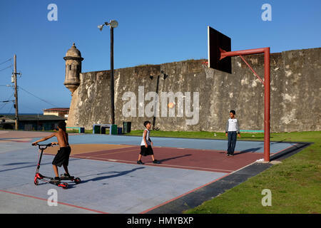 Les enfants jouer au basket-ball sur une cour extérieure à l'hôtel La Perla quartier dans la vieille ville de San Juan, Puerto Rico. Banque D'Images