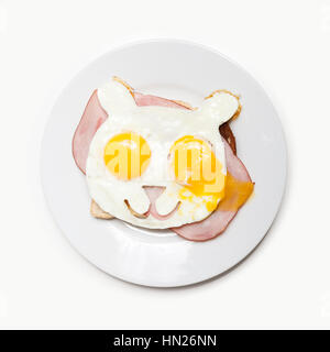 Oeufs frits à la forme d'un ours sur des toasts avec du jambon. Banque D'Images