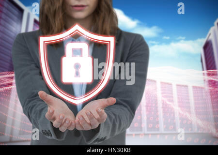 Businesswoman gesturing against white background contre composite image server towers Banque D'Images