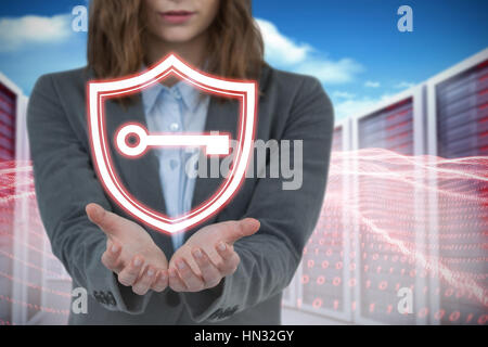 Businesswoman gesturing against white background contre composite image server towers Banque D'Images