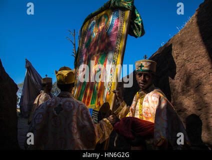 Moines en tenant hors de Mariam rock church les drapeaux pour Timkat celebration, région d'Amhara, Lalibela, Éthiopie Banque D'Images