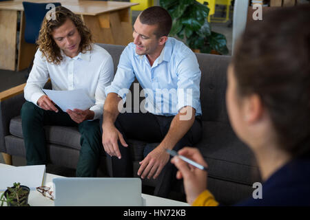 Business Executives discussing over document in office Banque D'Images