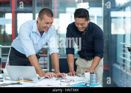 Business Executives discussing over document in office Banque D'Images