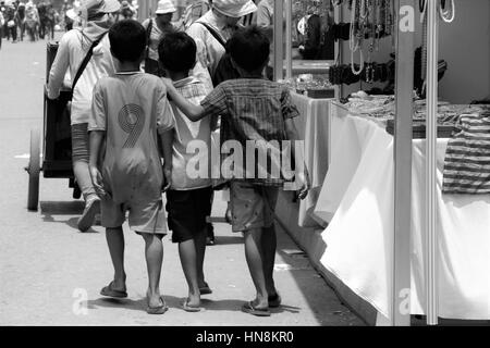 Amis d'enfance la vente de jus d'orange aux passants au Cambodge Banque D'Images