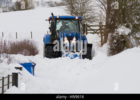 Agriculteur de tenter d'éliminer la neige profonde après une très forte chute de neige dans les régions rurales du nord du Pays de Galles Llangollen Banque D'Images